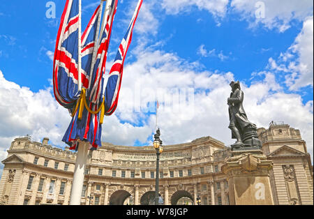 London, Great Britain -May 23, 2016: a bronze statue of captain james cook by thomas brock with flags at admiralty arch Stock Photo