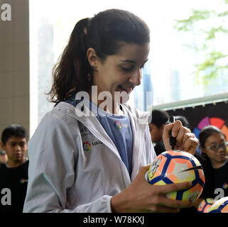 Spanish badminton champion Carolina Marin, signs autographys for young local footballl players during an event to promote La Liga, the Spanish footbal Stock Photo