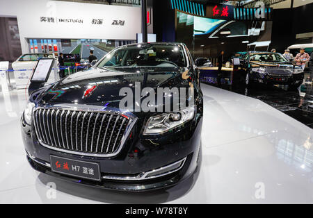 --FILE--Chinese visitors look at a Hongqi (Red Flag) LS5 of FAW on display during the 14th Beijing International Automotive Exhibition, also known as Stock Photo