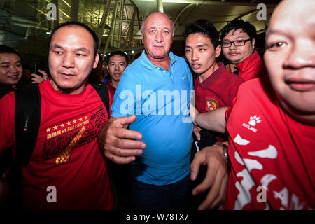 Former head coach Luiz Felipe Scolari of Guangzhou Evergrande is surrounded by Chinese fans before leaving the Guangzhou Baiyun International Airport Stock Photo