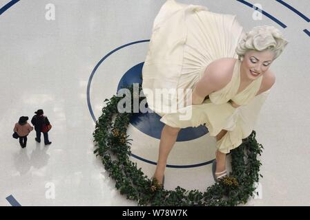 An eight-meter-tall sculpture of American actress and model Marilyn Monroe, frozen with her dress blowing up, is on display at a shopping mall in Dali Stock Photo