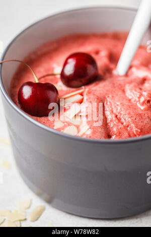 Healthy vegan breakfast bowl. Berries cherry smoothie in a gray bowl. Stock Photo