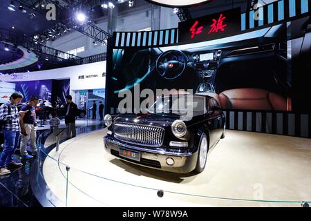 --FILE--Chinese visitors look at a Hongqi (Red Flag) LS5 of FAW on display during the 14th Beijing International Automotive Exhibition, also known as Stock Photo