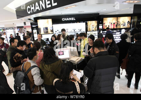 Chinese tourists crowd a store of Chanel at a shopping mall in Seoul, South Korea, 30 November 2013. Stock Photo