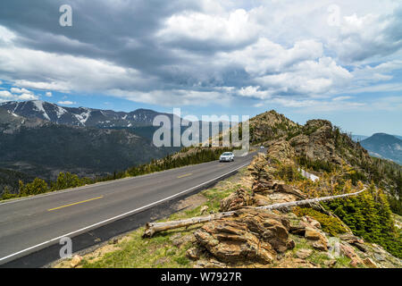 Trail Ridge Road - A stormy Spring day view of a narrow section of Trail Ridge Road winding at top of mountains. Rocky Mountain National Park, CO, USA. Stock Photo