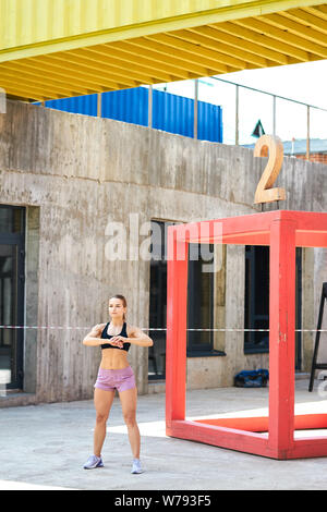 pleasant sportswoman with muscular legs doing morning exercises in the  street. full length side view photo. woman lossing weight Stock Photo -  Alamy