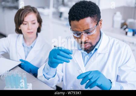 Two scientists working with testing tubes in the lab. Stock Photo