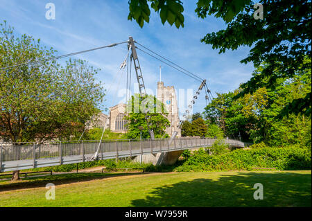 All Saints Church, Maidstone on the banks of the Meday on a sunny spring day. With Lockmeadow Footbridge in foreground Stock Photo