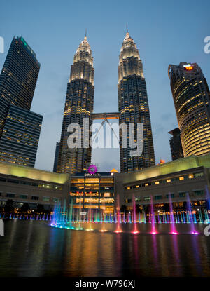 Petronas Twin Towers at dusk with coloured fountain Stock Photo