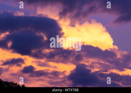 Photograph of a purple and yellow cloudy sky Stock Photo
