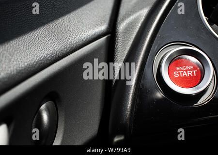 Red start engine button on a car's cockpit Stock Photo