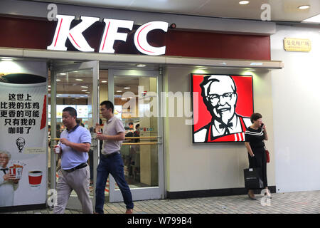 --FILE--Pedestrians walk past a fastfood restaurant of KFC of Yum! Brands in Shanghai, China, 30 August 2017.   It all began in Beijing. By November 1 Stock Photo