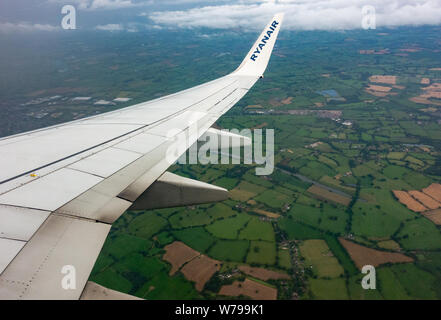Wing on a Ryanair Boeing 737 - 800 entering british airspace on route to Manchester Airport, England Stock Photo