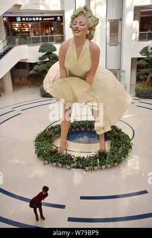 An eight-meter-tall sculpture of American actress and model Marilyn Monroe, frozen with her dress blowing up, is on display at a shopping mall in Dali Stock Photo