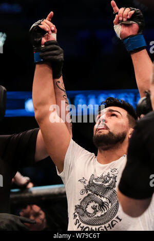 American mixed martial artist Kelvin Gastelum poses to celebrate after defeating British mixed martial artist and actor Michael Bisping during the 201 Stock Photo