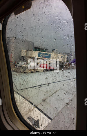 Heavy rain on a plane window on arrival at Manchester Airport Stock Photo