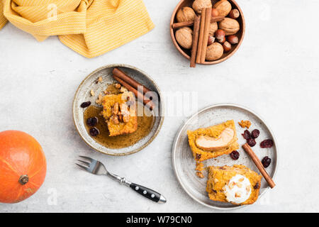 Apple and Pumpkin coffee cake with cinnamon, walnuts and maple syrup. On grey concrete background. Top view. Autumn comfort food Stock Photo
