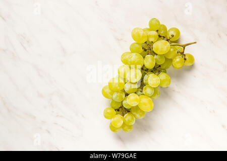 Tasty green grapes. White grape on white table. Stock Photo