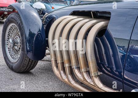 Giant exhaust system on a Ronart W152 car at Bill Rawles Classic Cars, Medstead, Hampshire, UK Stock Photo