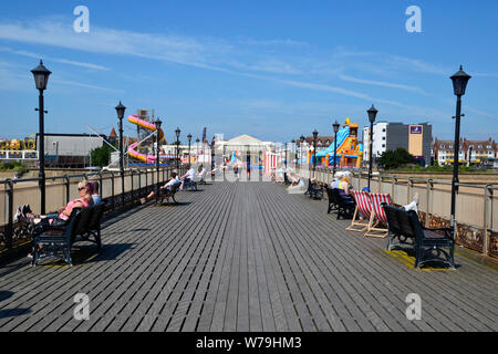 People relaxing on Skegness Pier, the seafront, Skegness, Lincolnshire, UK Stock Photo