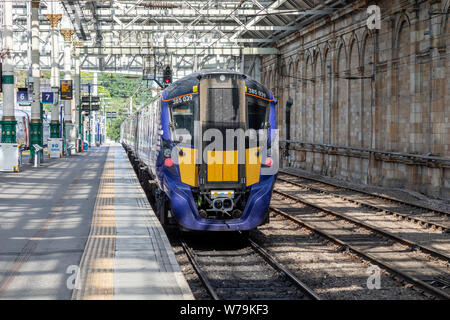 A Scotrail Class 385 Hitachi Train sitting at Platform 7 of Edinburgh Waverley train station Stock Photo