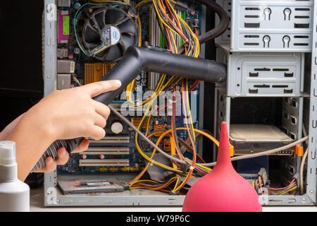 2019.07.17. Odessa. Ukraine. The system unit of a personal computer in dust and cobwebs. Teen boy 10 years old vacuuming computer parts Stock Photo