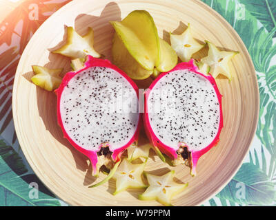 Dragon fruit and carambola cut on the table top view. Stock Photo