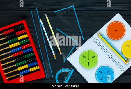 Creative Сolorful math fractions on dark background. Interesting funny math for kids. Education, back to school concept. Geometry and mathematics