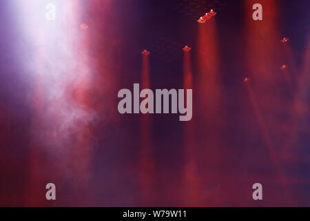 Red stage lights and smoke on live concert. Stock Photo