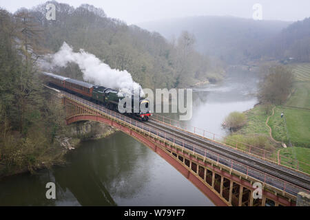 Nr Bewdley, Worcestershire, UK. A special Mother's Day service steam train chugs slowly over the Victoria Bridge crossing the River Severn.