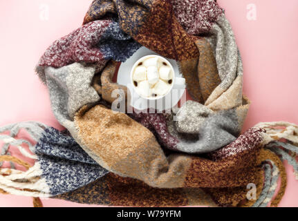Warm, cozy winter clothing, scarf, lightbox and christmas decorations  as frame on pastel  pink background. Christmas concept flat lay. hello winter Stock Photo