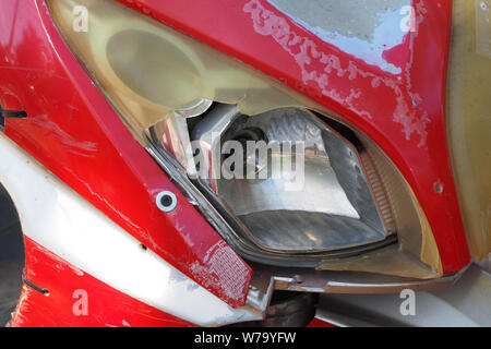 Close up view old broken scooter headlight. Stock Photo