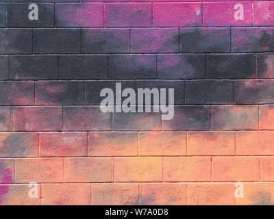 Brick wall of large blocks painted with bright colors. Stock Photo