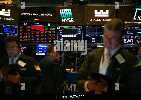 New York, USA. 5th Aug, 2019. Traders work at the New York Stock Exchange in New York, the United States, on Aug. 5, 2019. U.S. stocks plunged on Monday as investors worry that U.S. President Donald Trump's threatened new tariffs on Chinese imports will worsen trade prospects. The Dow Jones Industrial Average decreased 767.27 points, or 2.90 percent, to 25,717.74. The S&P 500 fell 87.31 points, or 2.98 percent, to 2,844.74. The Nasdaq Composite Index was down 278.03 points, or 3.47 percent, to 7,726.04. Credit: Guo Peiran/Xinhua/Alamy Live News Stock Photo