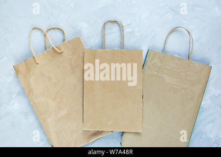 Flat lay of paper wastes as bags, boxes ready for recycling on gray background. Ecology care and social responsibility concept. empty paper bags for s Stock Photo