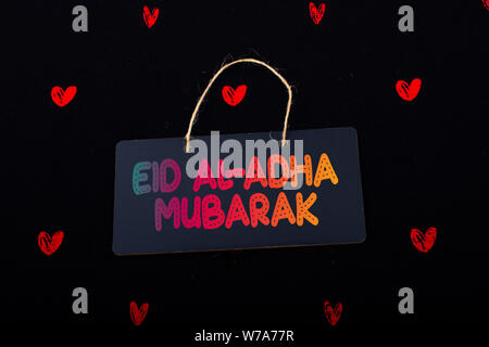 Rectangular shaped black notice board  and red hearts on black background Stock Photo