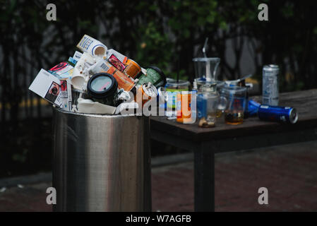 picture of overflowing trash in a metropolis, waste problem in a large city, overflowing trash can Stock Photo