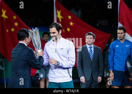 Roger Federer of Switzerland is awarded with the winner's trophy after defeating Rafael Nadal of Spain in their final of men's singles during the Shan Stock Photo