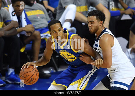 Shaun Livingston, left, of Golden State Warriors, competes with Tyus Jones of Minnesota Timberwolves in a basketball match during the NBA China Games Stock Photo