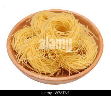 bunches of nested noodle pasta in wooden bowl isolated on white background Stock Photo