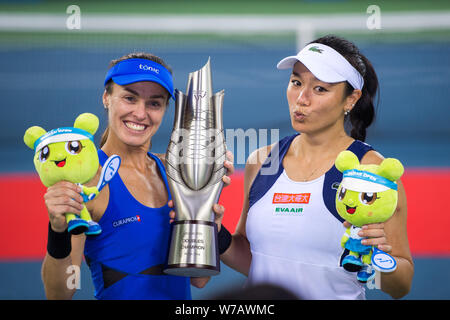 Chan Yung-Jan of Chinese Taipei, right, and Martina Hingis of Switzerland pose with their trophy after defeating Shuko Aoyama of Japan and Yang Zhaoxu Stock Photo