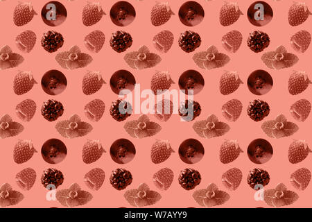 Fruit pattern. Colorful of fresh blueberry, raspberry, strawberry, fruits texture slices on coral pastel background. From top view. Stock Photo