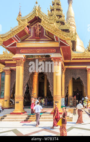 Yangon, Myanmar-May 6th 2014: People visiting the Shwedagon Pagoda. The pagoda is the most sacred in all of Myanmar. Stock Photo