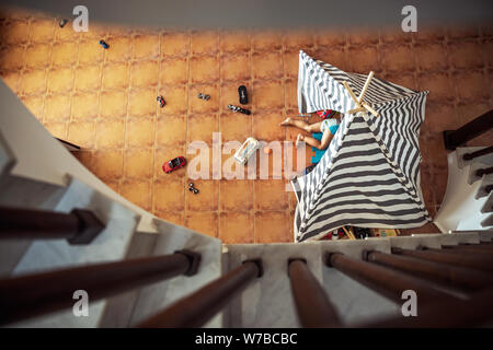 Baby boy playing at home, lying down in his tent, top view from up, little playful kid, happy carefree childhood Stock Photo