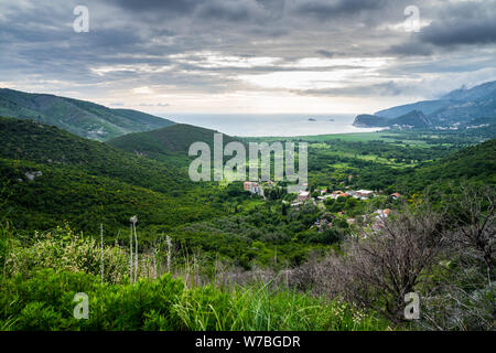Montenegro, Green valley of petrovac bay near budva in warm sunset light at adriatic sea coast nature landscape Stock Photo