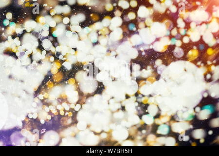 Abstract Festive background. Glitter vintage lights background with lights defocused. Christmas and New Year feast bokeh background with copyspace. Stock Photo