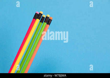 Five colorful pencils with erasers are lying on azure background isolated Stock Photo