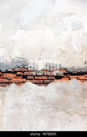 Grunge background with texture of old brick wall and cracked stucco of white color Stock Photo