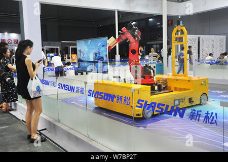 --FILE--Visitors look at a robot arm at the stand of Siasun Robot & Automation during the China International Robot Show in Shanghai, China, 7 July 20 Stock Photo