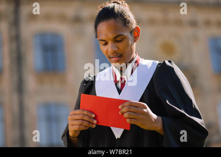 Smiling boy delivering a speech during the graduation. Stock Photo